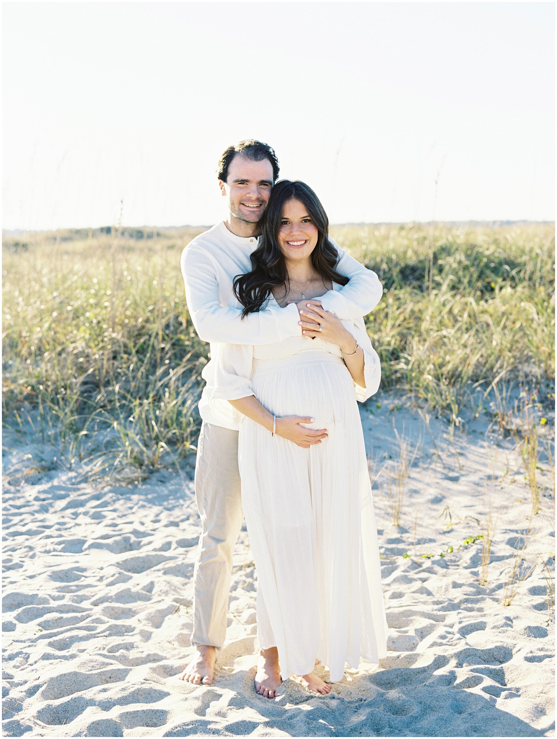 Wrightsville Beach maternity session at sunset with expecting couple photographed by a Wilmington NC family photographer