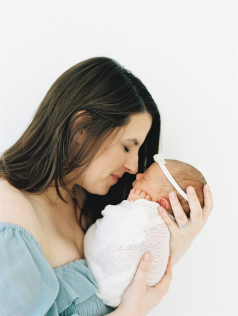 mom nose to nose with newborn baby in studio in Wilmington NC