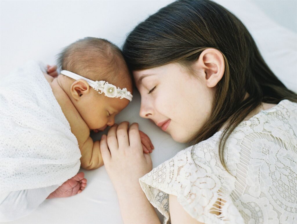 older siblings head to head with babying newborn photography In Wilmington NC