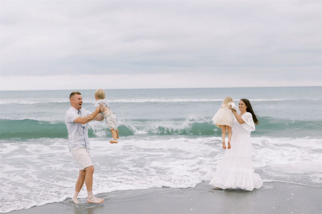family photos with parents throwing children in the air on Topsail beach