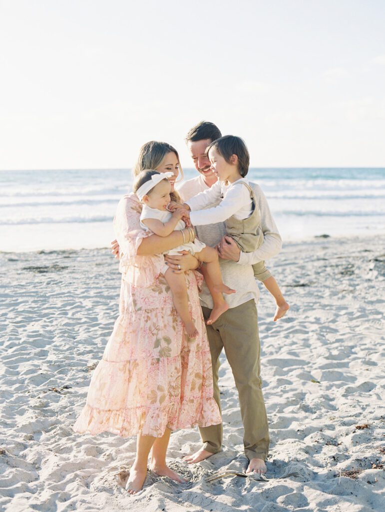 kids tickling each other on beach with family photographer Wilmington NC