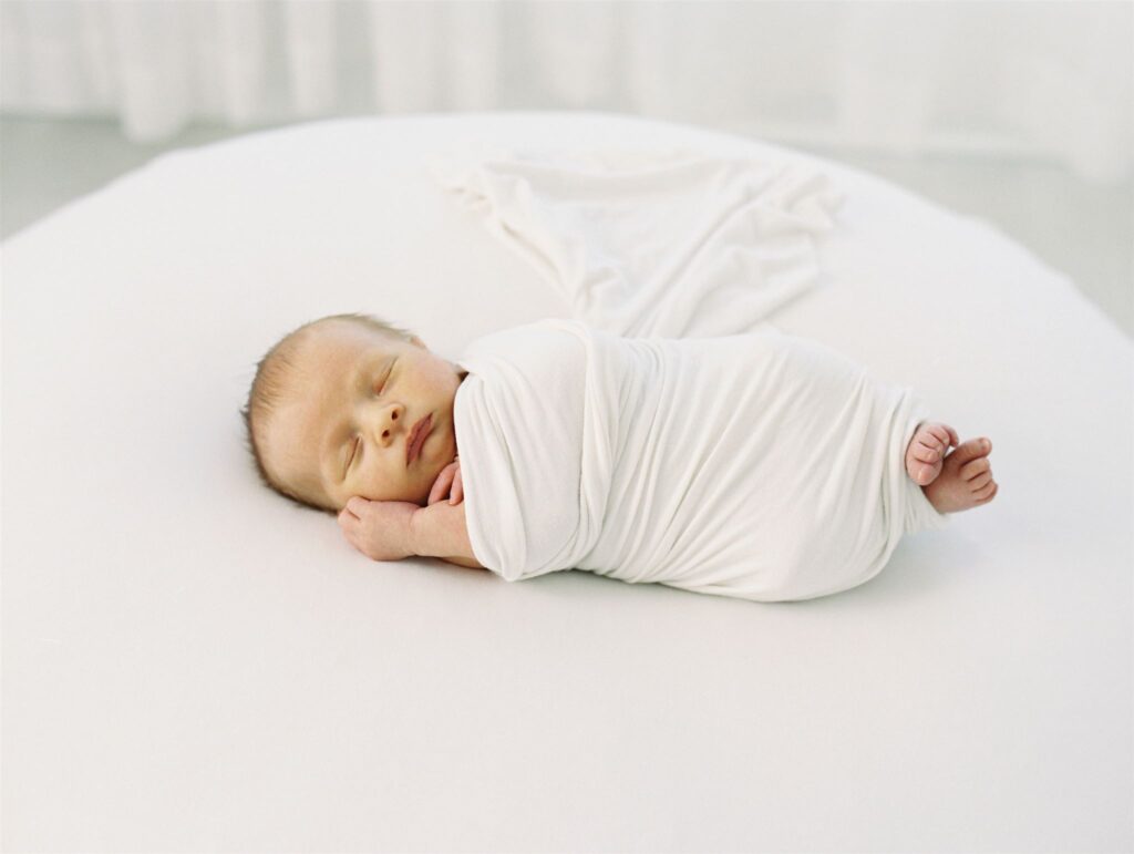 baby photographed on a bean bag by Hampstead NC Newborn Photographer
