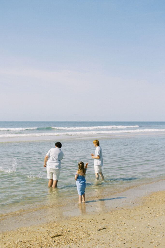 Children skipping shells during a Topsail Beach family photo session